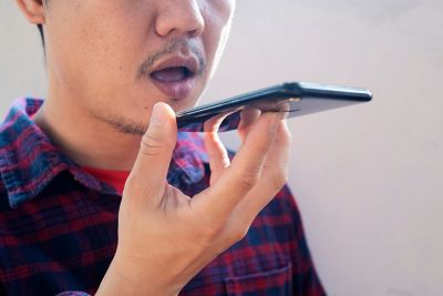 man speaking into smartphone